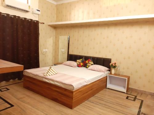 a bedroom with a large bed in a room at PAARIJAAT Homestay & Guesthouse in Ayodhya