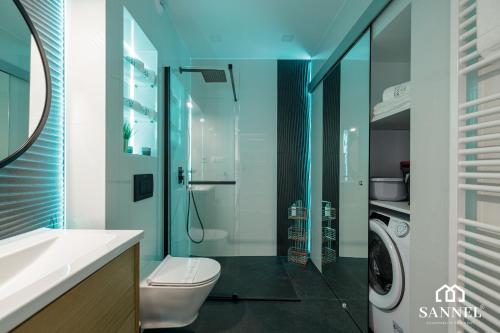 a bathroom with a toilet and a glass shower at Apartament Premium Sea-Pinea Apartments Pobierowo in Pobierowo