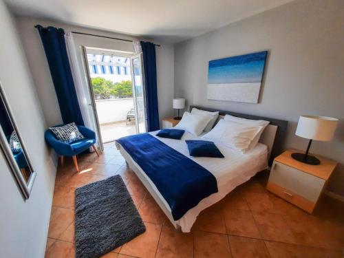 a bedroom with a large bed and a large window at House Anita in Krk