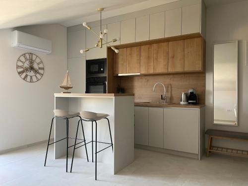 a kitchen with a counter and stools in it at Vitas Apartments in Zaton
