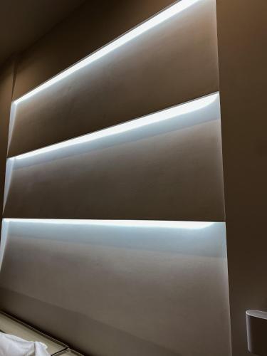 a row of lights on the side of a bed at Megaris Luxury Suite Rooms in Naples