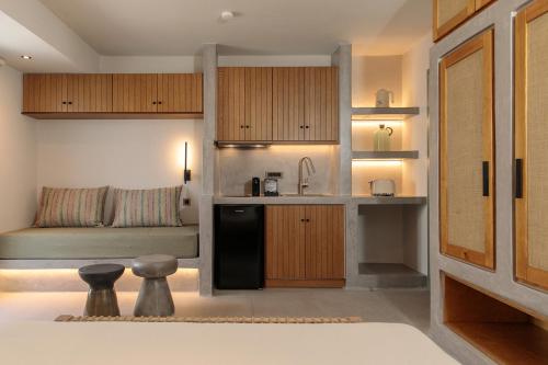 a kitchen with a sink and a couch in a room at "Makava Suites" Your Luxe Urban Sanctuary in Naxos Chora