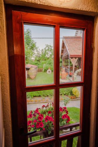 a window with a view of a garden with flowers at Apartment in Antique Museum Filip in Bitola