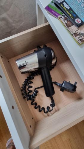 a hair dryer in a drawer of a table at City Nest. in Dublin