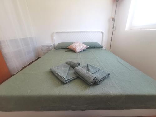 特里班的住宿－Apartmani Lešić，一张大床,上面有两条毛巾
