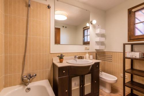 a bathroom with a sink and a toilet and a mirror at Las Palmeras by Ĥ - Playa Punta del Moral PLHP28P11 in Isla del Moral