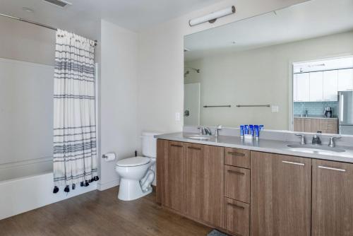 a bathroom with a sink and a toilet and a mirror at San Jose 1br w gym pool wd nr San Pedro Sq SFO-1312 in San Jose