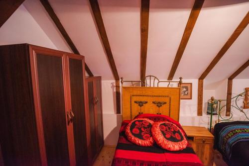 a bedroom with a bed with red pillows on it at Apartment in Antique Museum Filip in Bitola