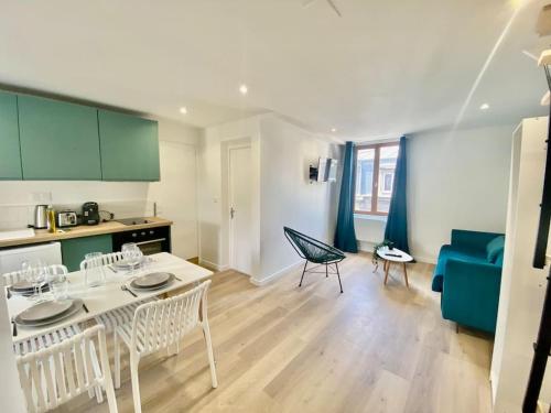une cuisine et un salon avec une table et des chaises dans l'établissement Le Primevère, à Rouen