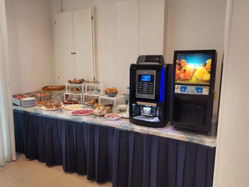 a ticket counter with a pay phone next to a cash machine at Hotel Sissi in Rimini