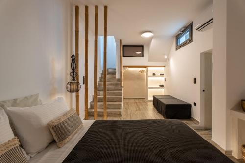 a bedroom with a bed and a staircase in the background at Ios Seaside house with sunset view and small pool in Ios Chora