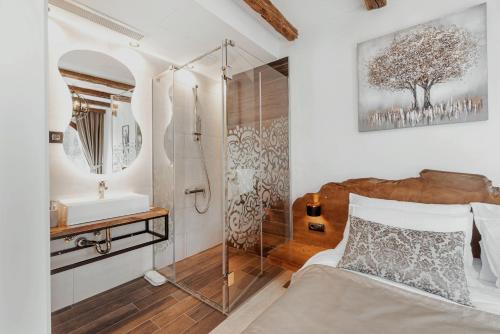 a bedroom with a shower and a bed and a sink at Toplik Village Resort in Lukavica