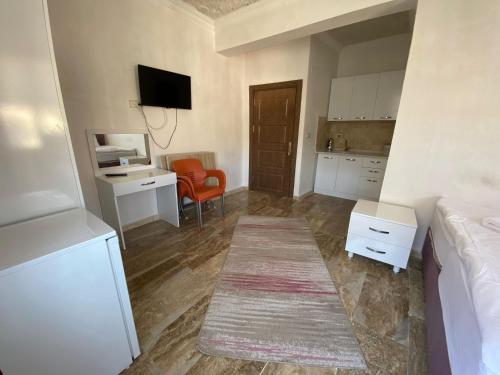 a room with a bed and a desk and a kitchen at KAPADOKYA DELUXE APART in Ürgüp