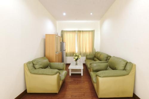 a living room with two couches and a table at June Pool Villa in Krabi town