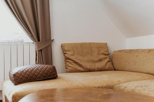 a living room with a couch and a window at Toplik Village Resort in Lukavica