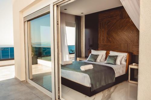 a bedroom with a bed and a large glass window at THE VIEW Premium Villas in Bar