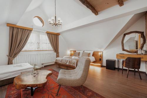 a hotel room with a bed and a table at Toplik Village Resort in Lukavica