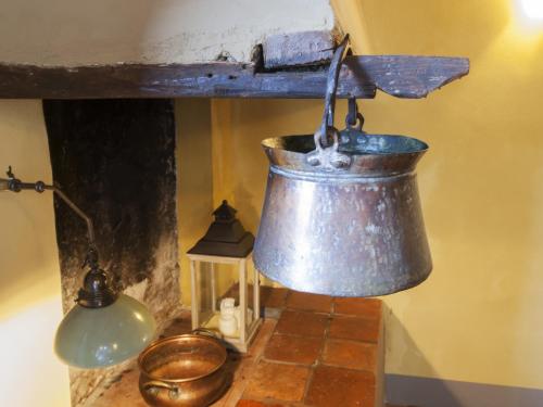 a bell hanging from a wall next to a stove at Le Stanze Del Duomo in Anagni