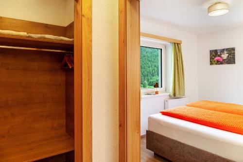a bedroom with a bunk bed and a window at Haus Alpenheim Apartment 3 in Tux
