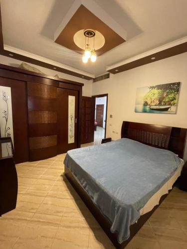 a bedroom with a bed and a ceiling at El Andalous Apartments in Hurghada