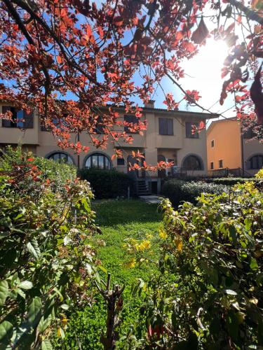 a building in the background with trees in the foreground at Casa Pruno Rosso in Montemerano