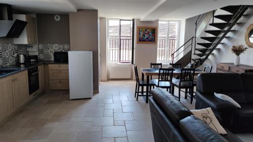 a kitchen and a living room with a table and chairs at GITE DE L'AETI JACUZZI PISCINE in Beine