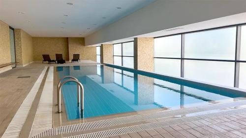 a large swimming pool in a large building at Troia Garden View Apartment in Troia