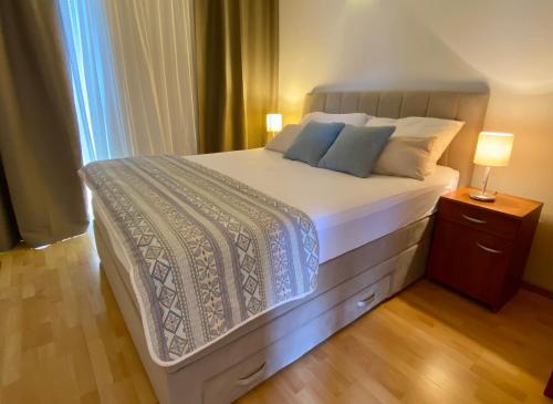 a bedroom with a large bed with two pillows at Apartmani Perić in Stari Grad