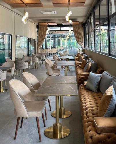 a restaurant with couches and tables and chairs at RAWAN RESIDENCY in Oujda