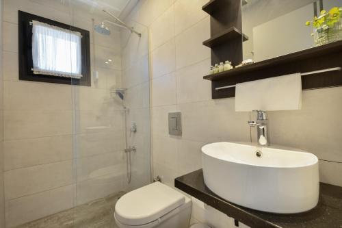 a bathroom with a white sink and a toilet at Villa Lui Hotel Alaçatı in Ilıca