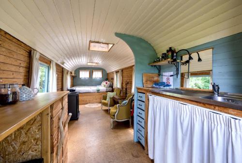 a kitchen with a counter and a sink in a room at La Roulotte de la Ferme de Froidefontaine in Havelange