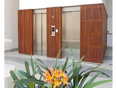 a plant in front of a row of elevators at Estudio en Puerto Norte con PILETA incluida y COCHERA opcional in Rosario