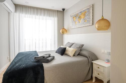 a bedroom with a bed with two towels on it at Apartamento Suite Gran Vía in Murcia