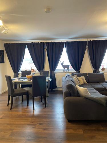a living room with a couch and a dining room table at Harzstübl25 in Sankt Andreasberg