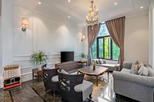 a living room with a couch and a table at Rex Quang Binh Hotel in Dong Hoi