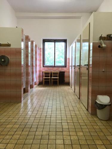 an empty bathroom with a toilet and a window at Nezámek in Hartmanice