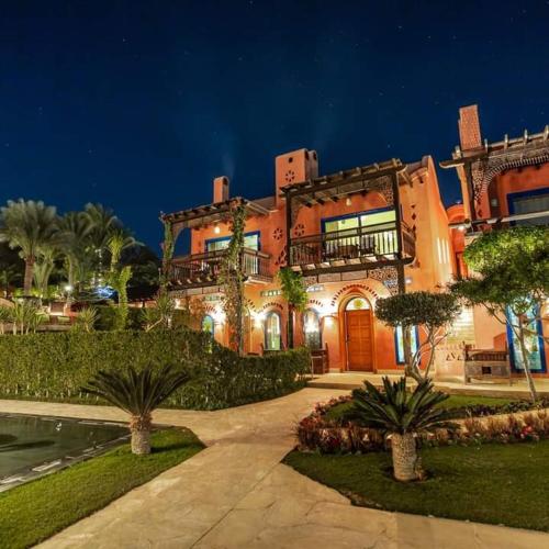 a large building with a walkway in front of it at Lazib Inn Resort & Spa in Tunis