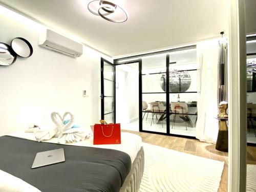 a bedroom with a bed with a red bag on it at Gran-Via Luxury Flat 3BD City Center + Terrace + AC in Madrid