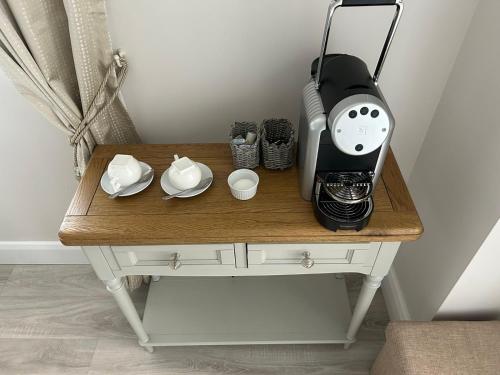 a coffeemaker on a table with a coffee maker at Rooms At Mcternans in Kilcullen