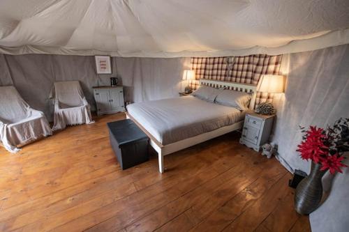 a bedroom with a bed and a table and a chair at Glamping in Llanberis in Llanberis