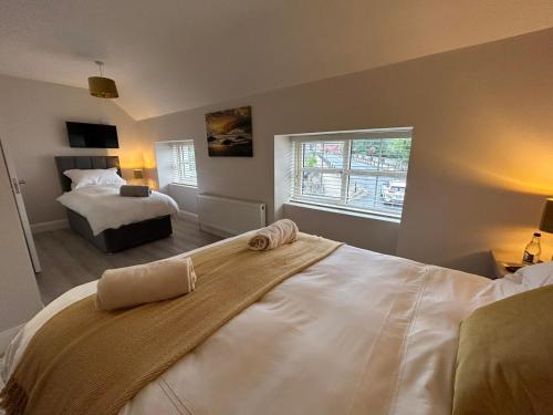 a bedroom with a large white bed and a window at Rooms At Mcternans in Kilcullen