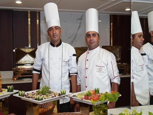 a group of chefs standing in a kitchen at Hotel ND Manor in Dehradun