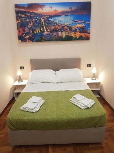 a bedroom with a bed with two towels on it at GISELLE in Naples