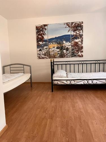 a room with two beds and two paintings on the wall at Ferien am Maar in Daun