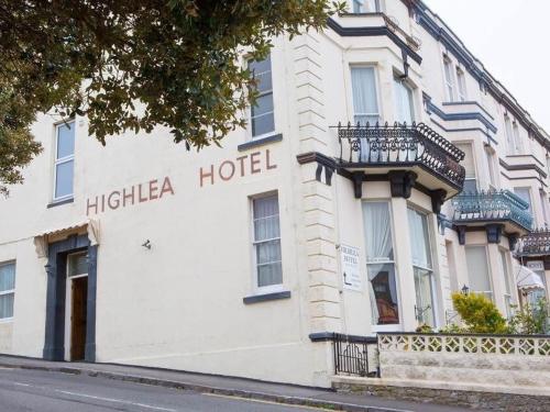 a white building with the hitza hotel on it at Highlea Guest House in Weston-super-Mare