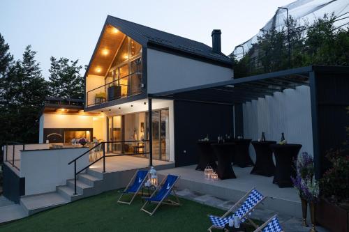 a home with a patio with chairs and a bar at Copanjek Country House in Plešivica