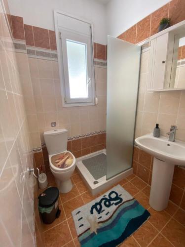 a bathroom with a shower and a toilet and a sink at nikol_house in Alepou