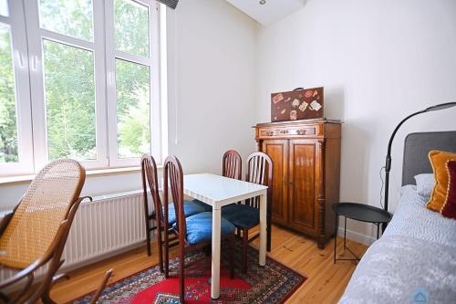 een eetkamer met een tafel en stoelen en een bed bij Travel by 3City Rentals in Sopot