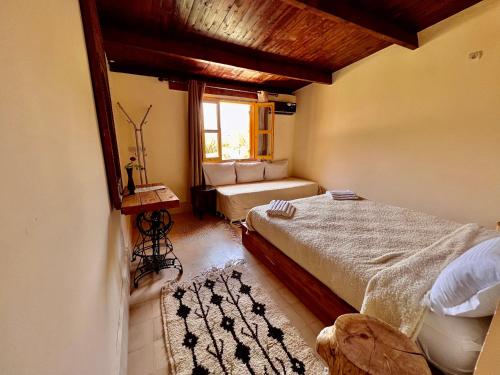 a bedroom with a large bed and a window at Dar l'eau Vive in Bine el Ouidane