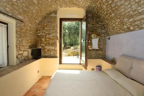 a room with a bed and a window and a couch at Agriturismo C'era Una Volta in Camporosso